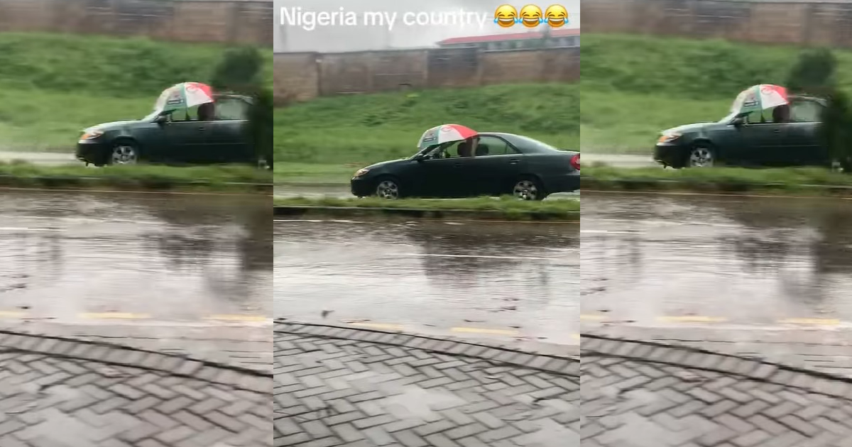 "The glass no fit wind up be that" – Driver refuses to close car window, opts for umbrella in heavy rain (VIDEO)