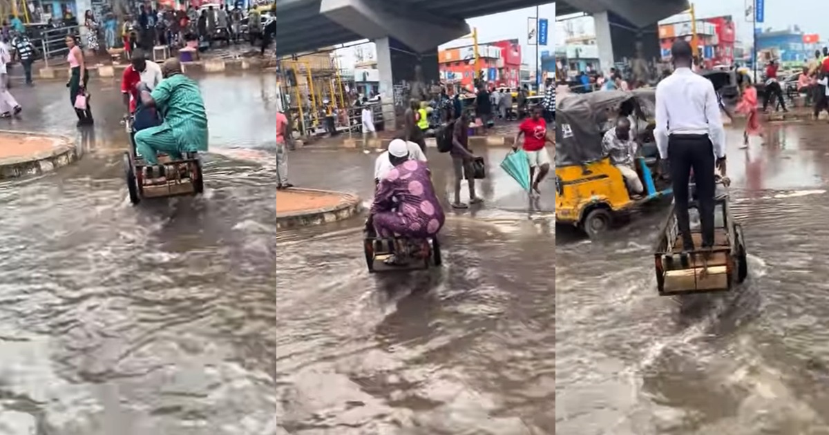 "Lagos, A state for hustlers" – Truck pusher unveils hustling spirit as he transports passengers amid fl00d in Computer Village, Ikeja (VIDEO) 