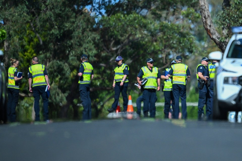 Police inspect the road as they begin their investigations