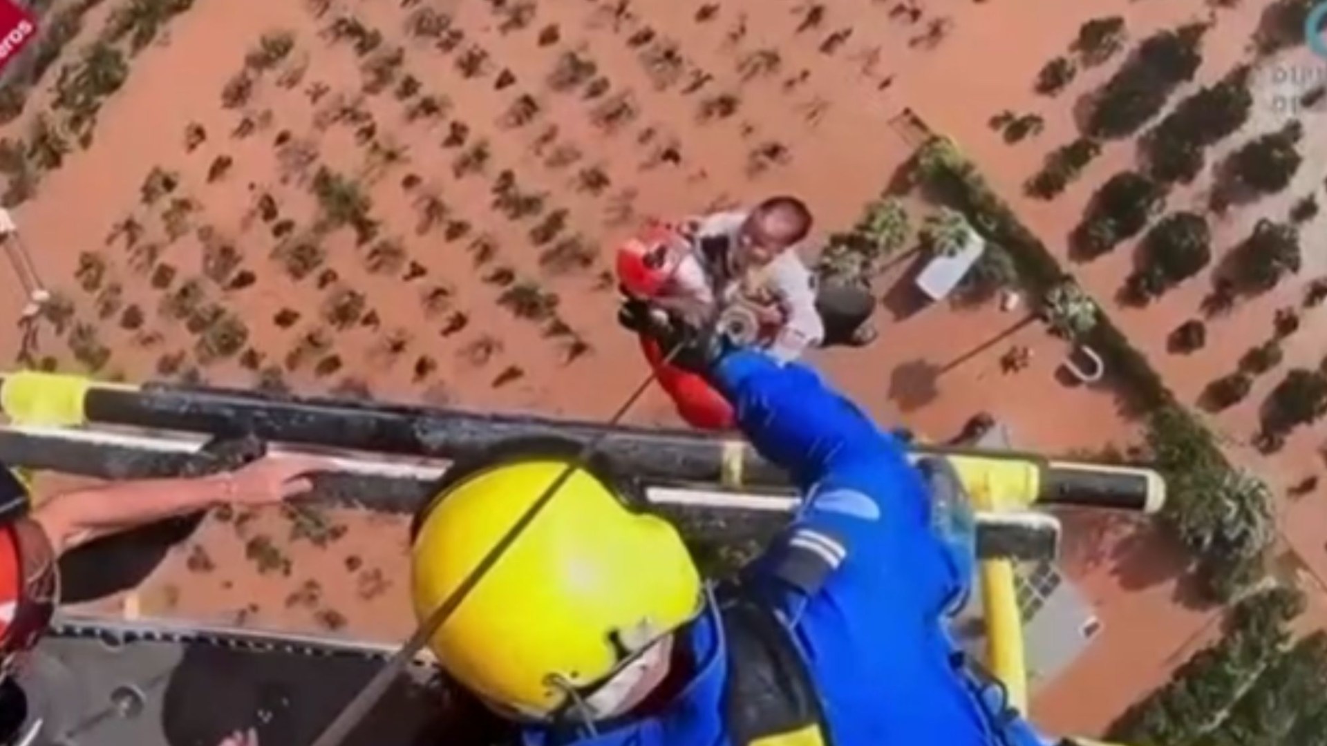 Moment rescuers airlift baby & elderly woman in flooded Spain amid painstaking rescue mission after at least 158 killed