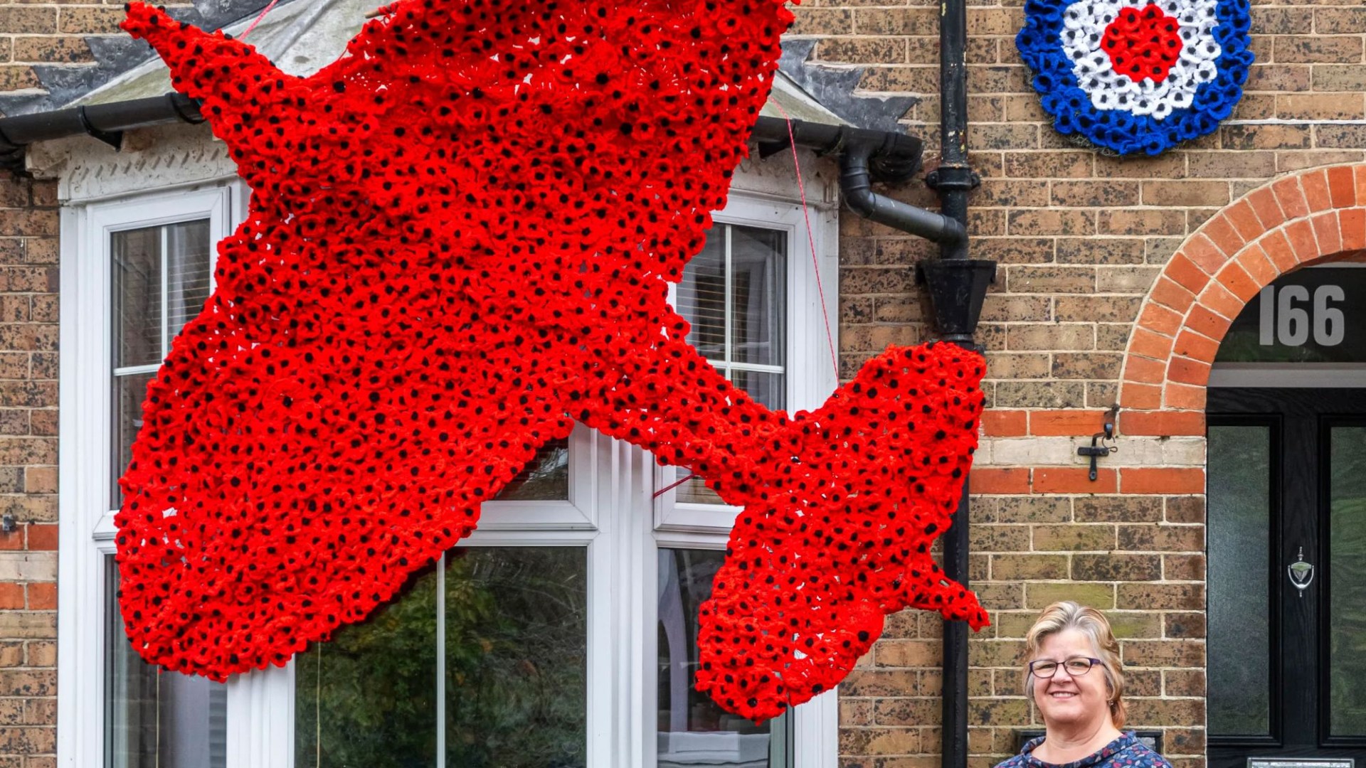 Remembrance Day fundraiser launches Spitfire poppy display outside her home