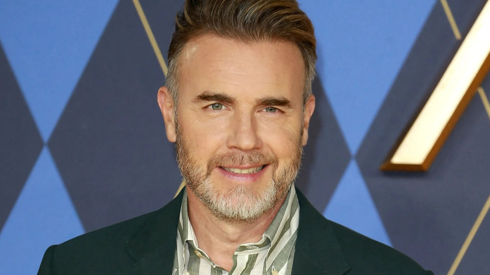 Gary Barlow reveals why his kids have shunned fame as he shares new pic of son, 24, towering over him