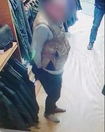 Images filmed inside a store show a crook stuffing gloves down his trousers