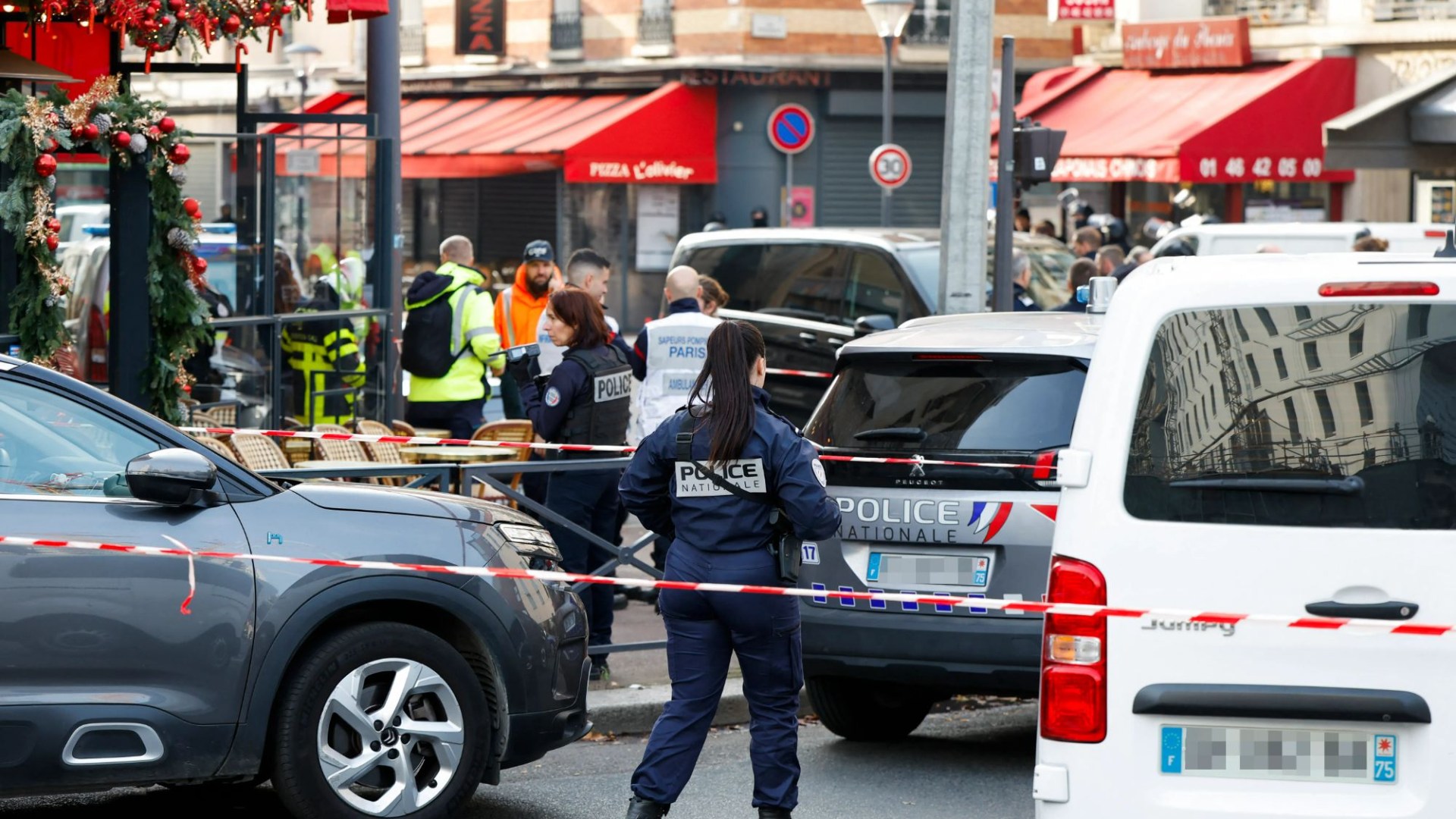 Knife-wielding man takes hostages in Paris pizza restaurant as armed special forces cops lock down street in siege