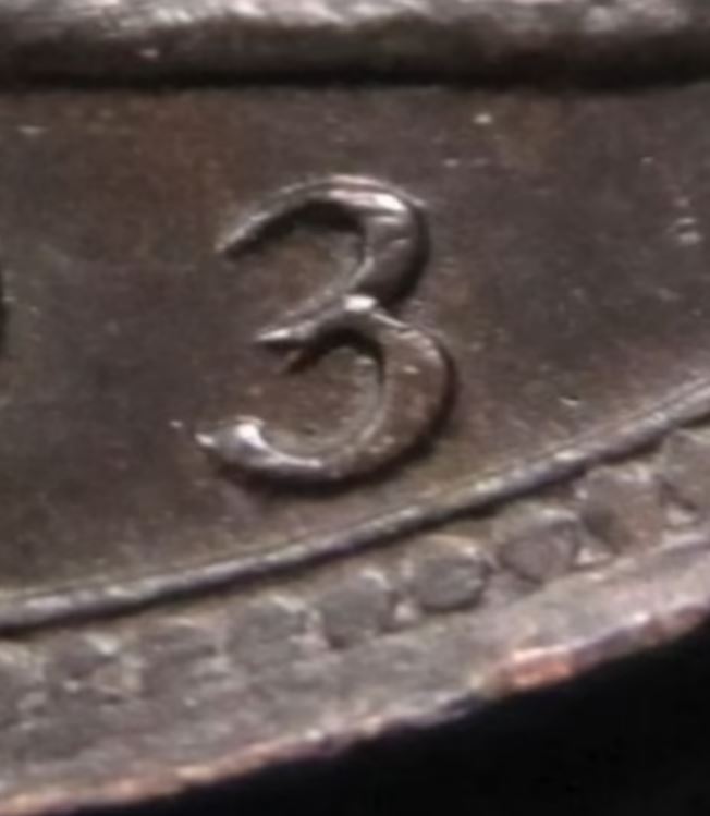 The 1893 coin has a mark that makes the three look like a two