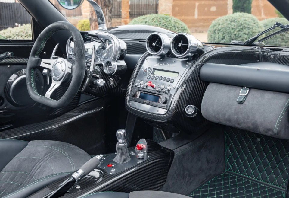 The car features an Alcantara-trimmed steering wheel, suede and leather bucket seats and green stitching detail throughout the interior to match the detail on the exterior