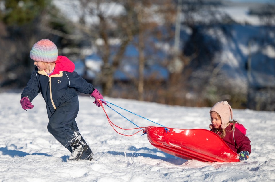 Evie Murison and her little sister Cora Murison sledging in Alford, Aberdeenshire