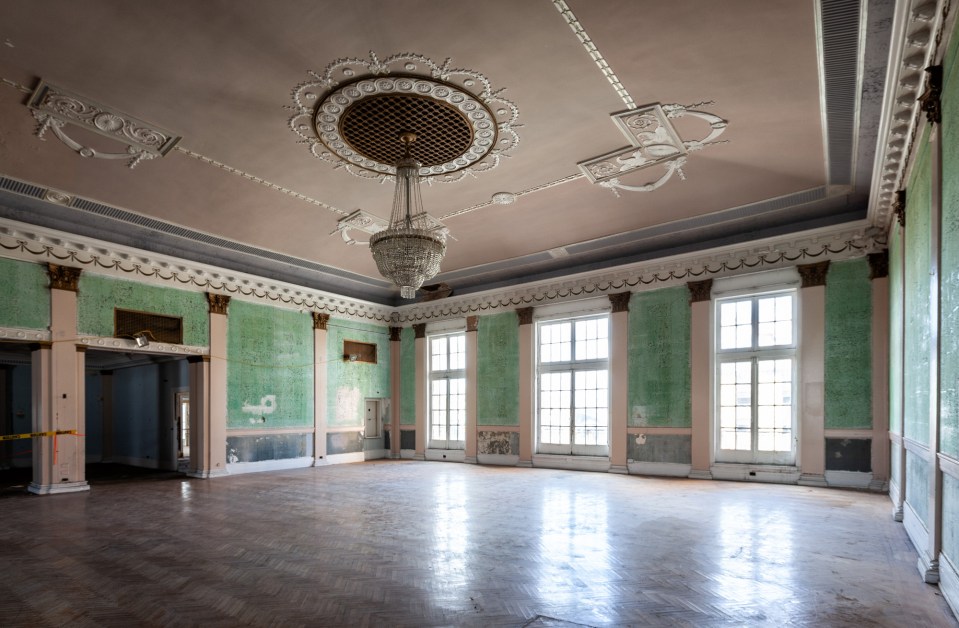 A chandelier still hangs in the once lavish ballroom of the hotel