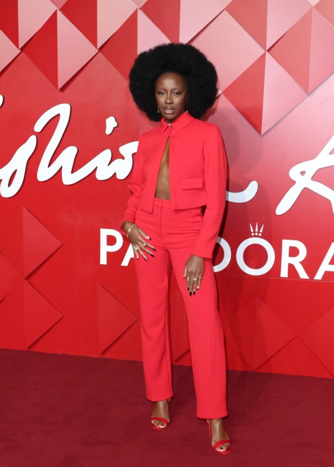 AJ Odudu made a striking appearance in a red tailored jacket and matching trousers