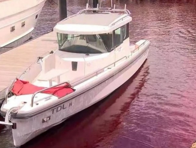 The stained water lapped up against boats and homes