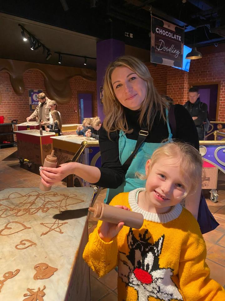 Millie and Mum Lauren getting their hands on the chocolate