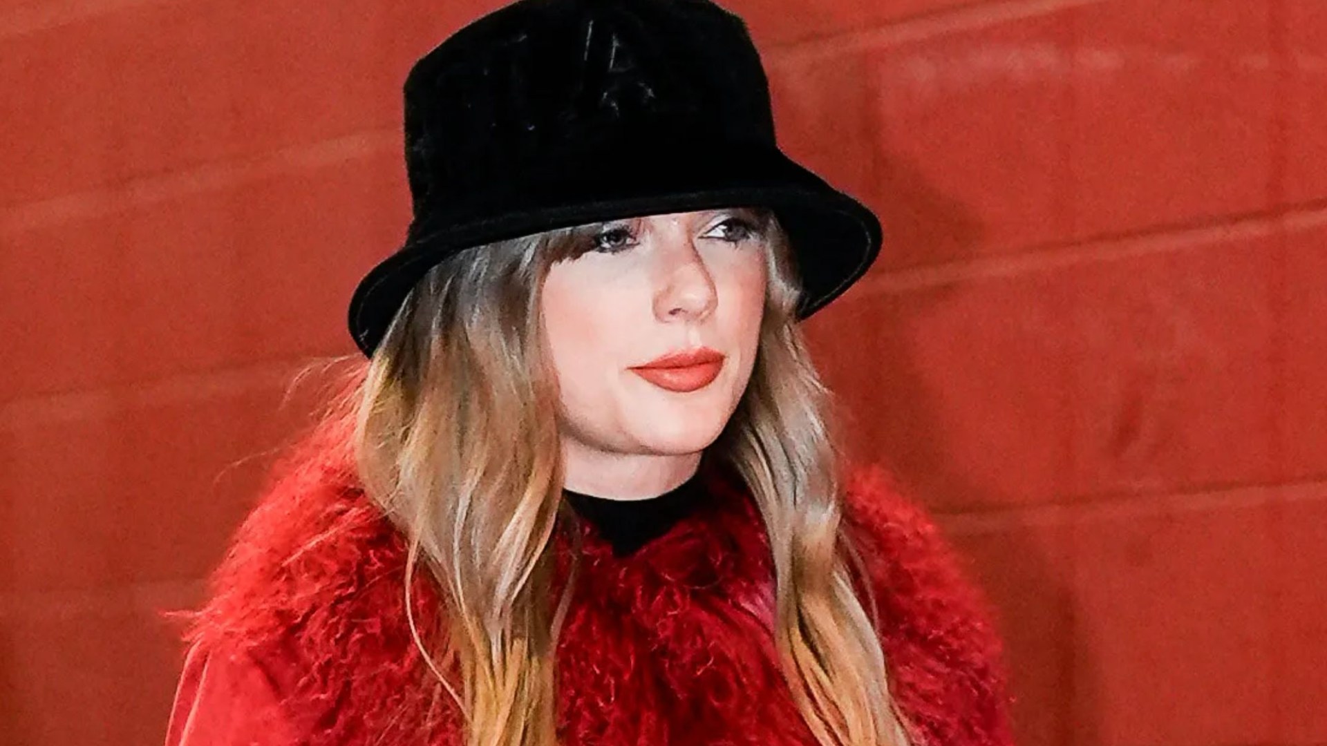 Taylor Swift snapped in furry red coat as she wraps up to watch Travis Kelce in NFL clash