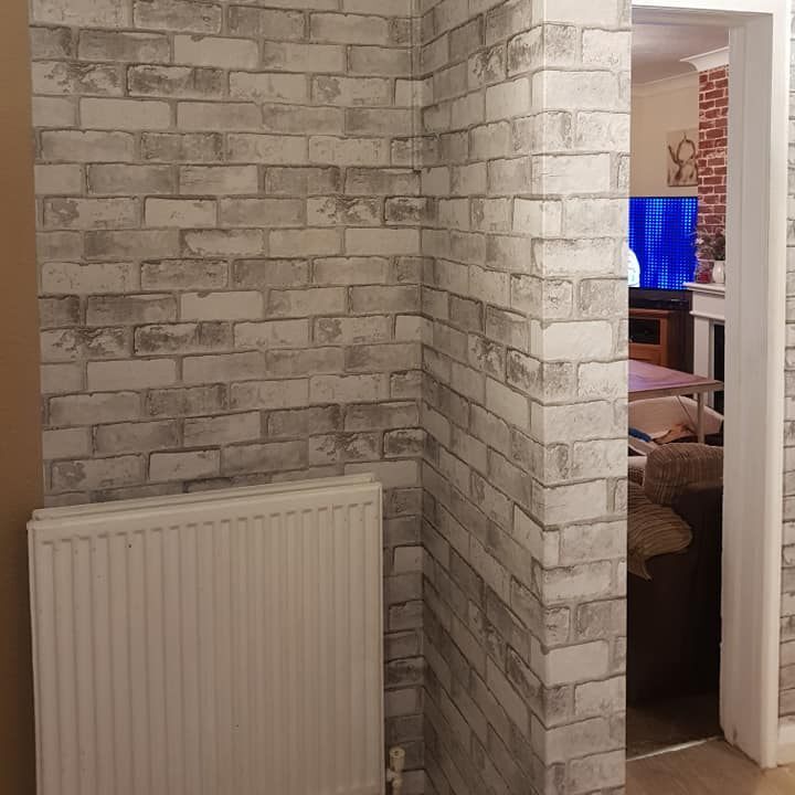 She used a brick effect wallpaper over the top of the woodchip