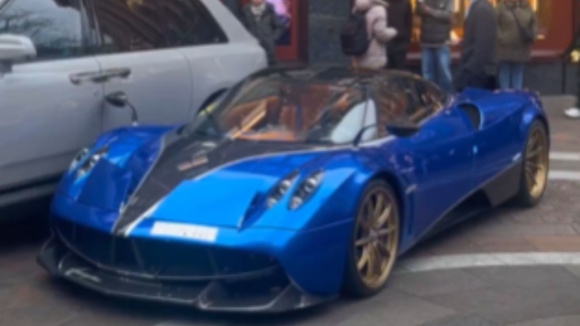 Moment driver who thoughtlessly parked £2MILLION Pagani supercar illegally on busy pavement gets instant karma