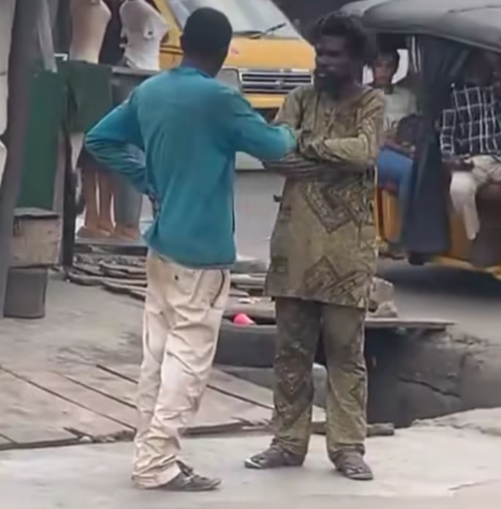 Moment two mentally challenged men were spotted conversing in a busy road