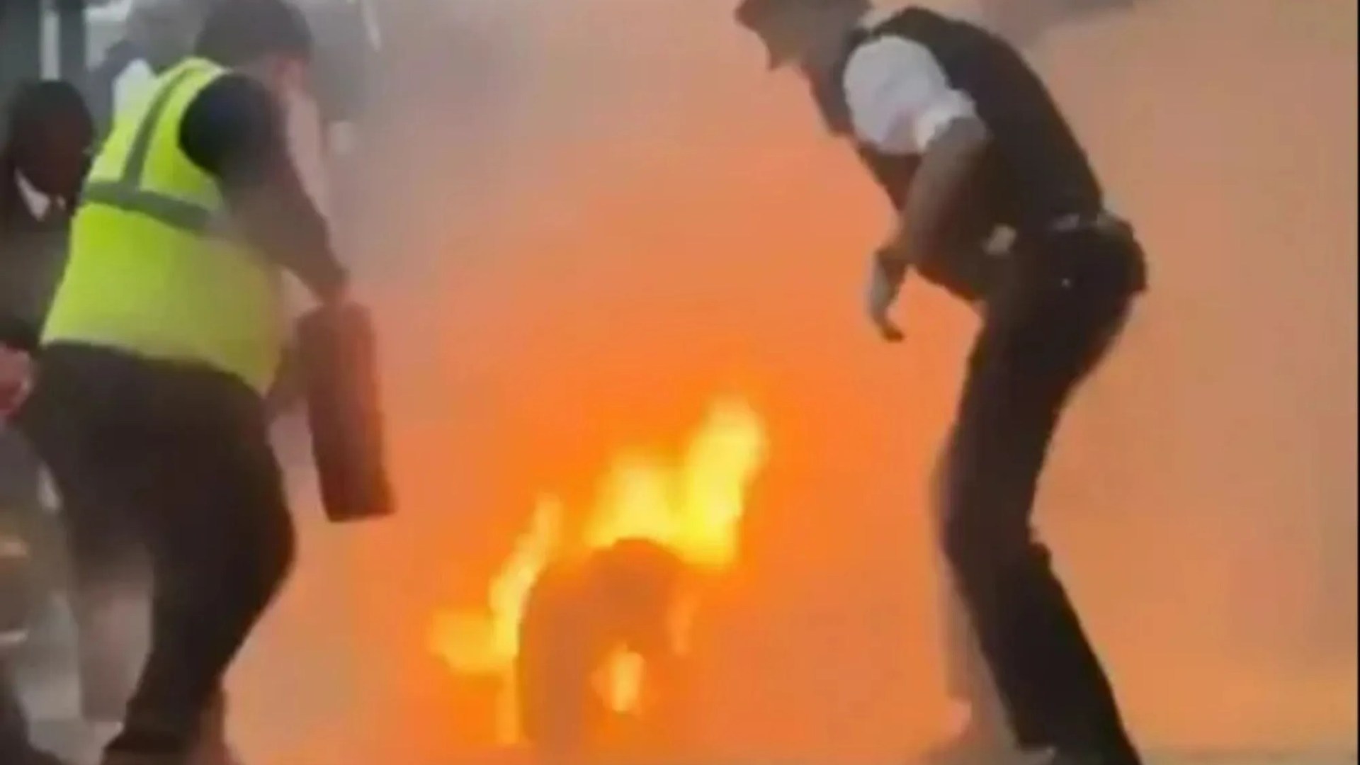 Terrifying moment brave cops desperately fight to put out flames after man sets himself on fire in front of onlookers