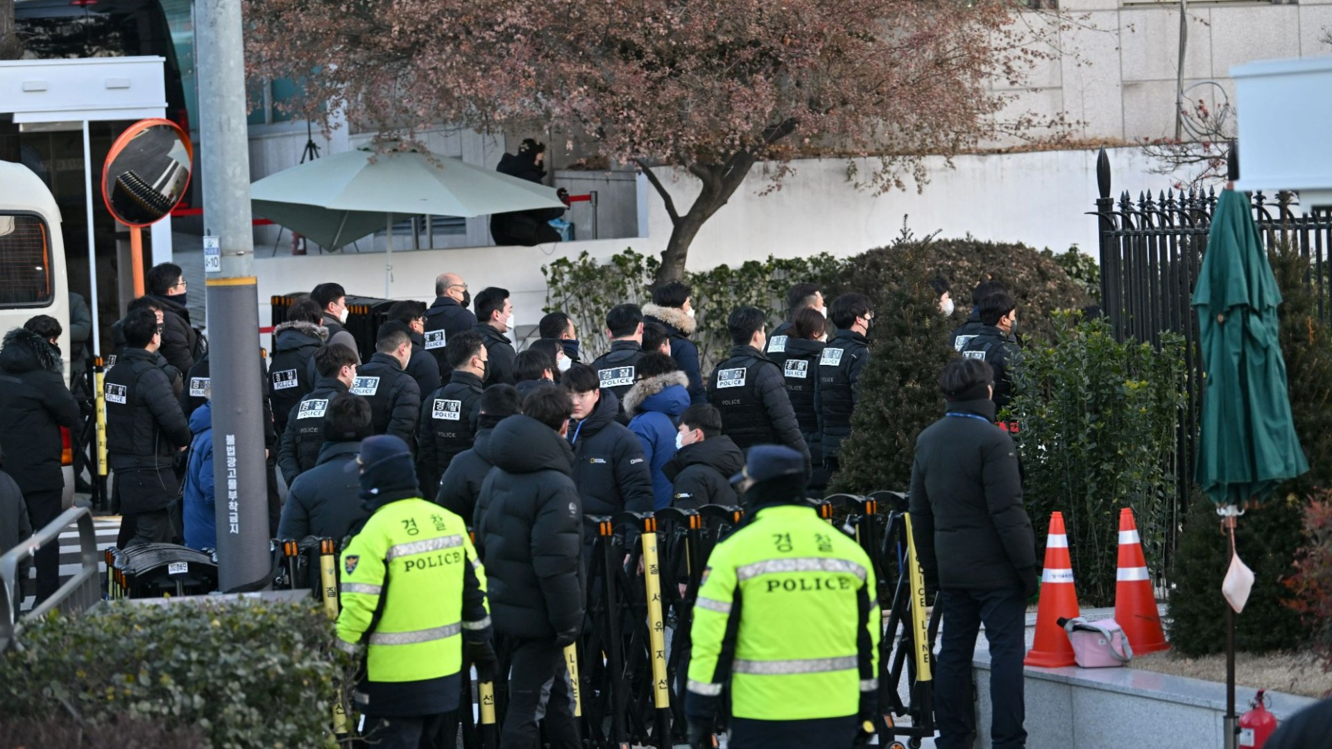 Riot police swarm home of impeached South Korean president after he imposed martial law as he vows to 'fight to end'