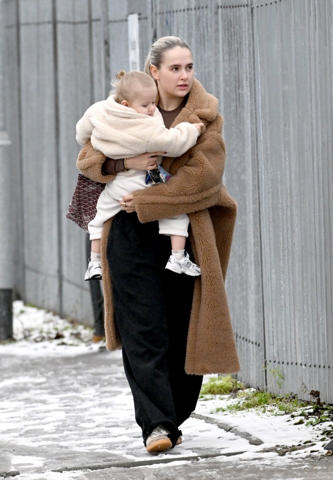 Molly held her daughter close as she walked in the snow