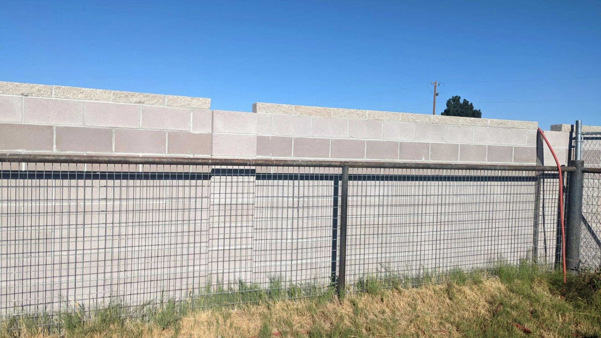 My neighbour put up an 'ugly' block WALL next to my existing fence - now it looks like I live in a prison