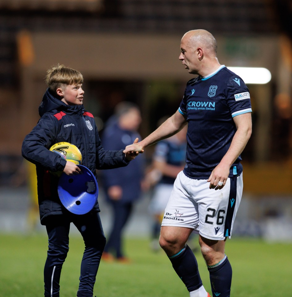 Ballboy shaking hands with Charlie Adam after a Dundee v Hibs game.