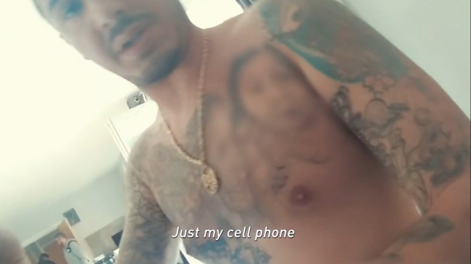 Screenshot of a man with tattoos, saying "Just my cell phone."