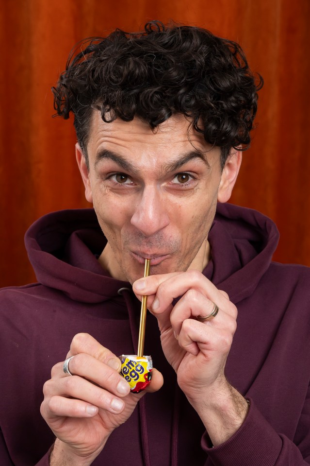 Man drinking from a Cadbury Creme Egg with a straw.