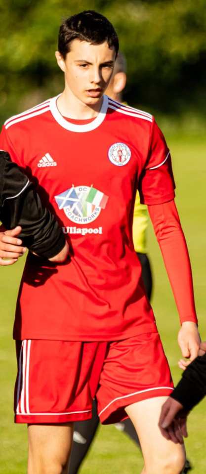 A young man in a red soccer uniform.