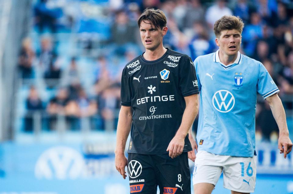 Two soccer players on a field.