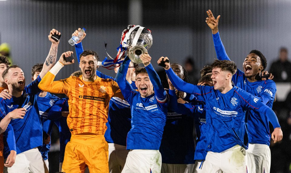 Rangers players celebrating a Glasgow Cup victory.