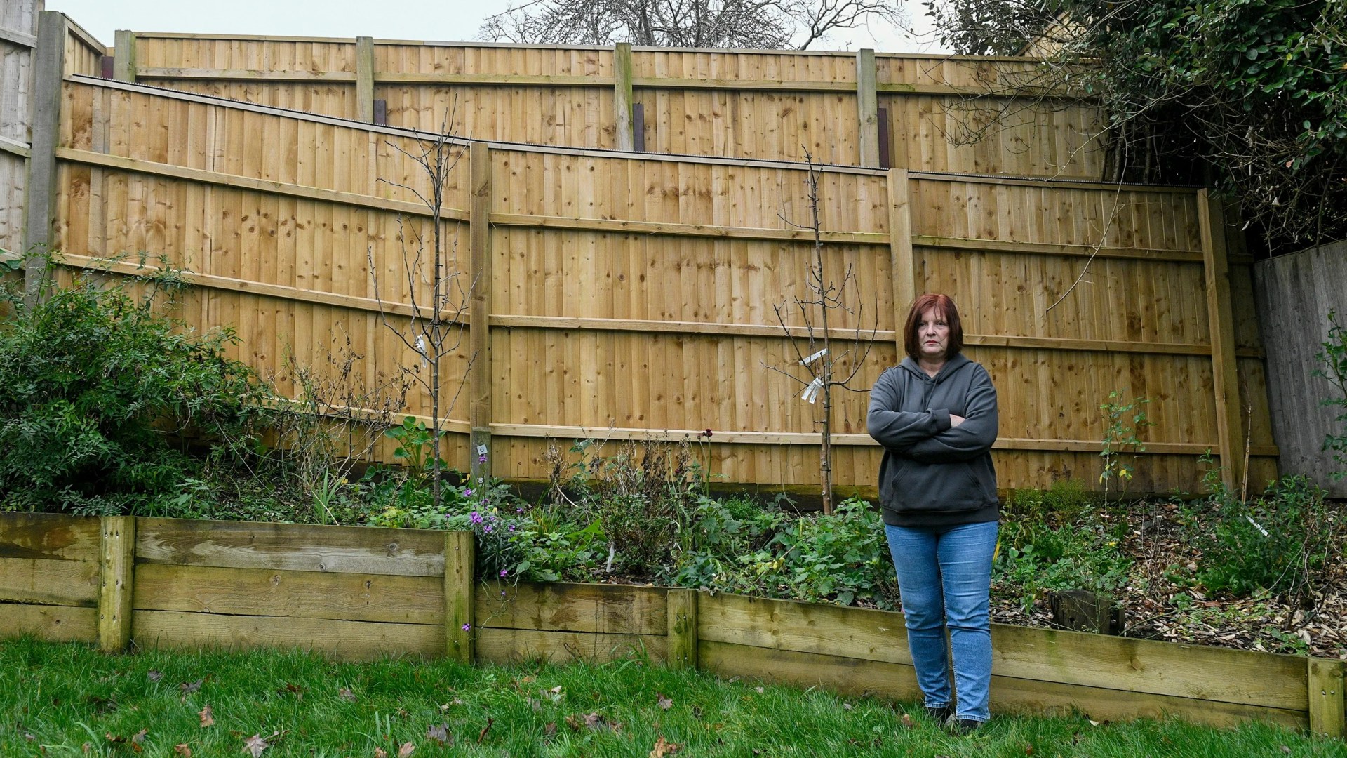 Our neighbour's spiked 10ft privacy fence towers over our garden... it's like living off a motorway or prison camp